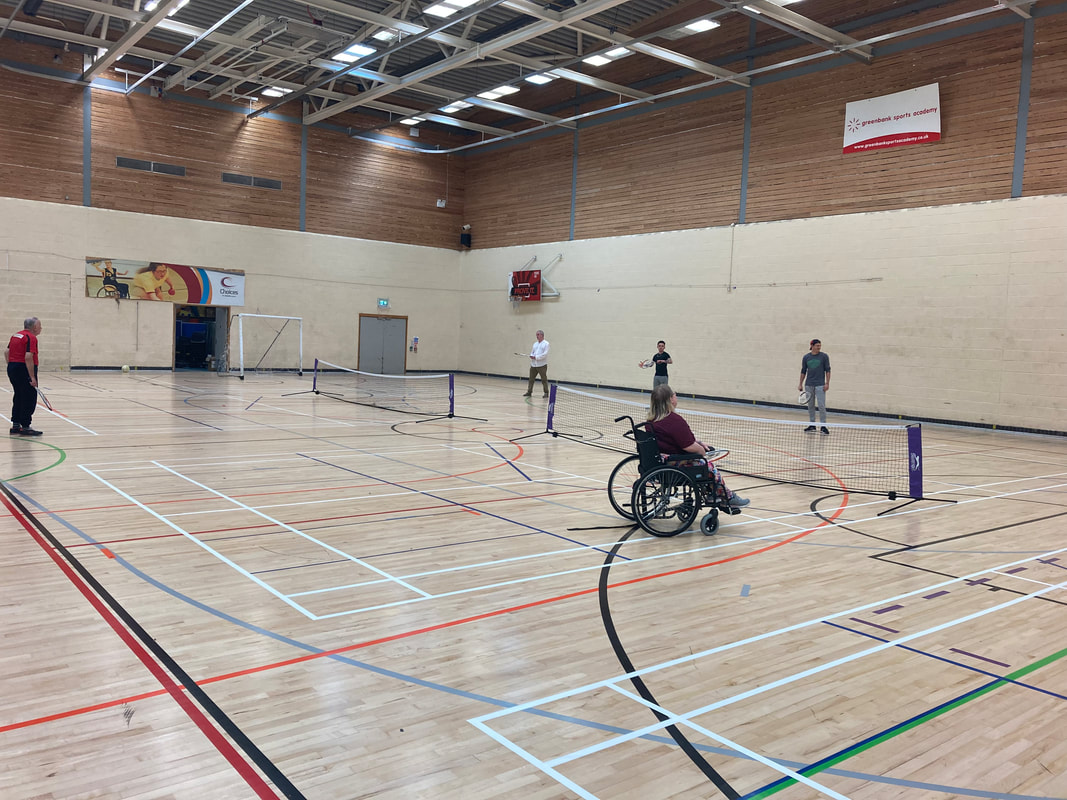 Photo shows participants playing tennis at one of our multi sports sessions