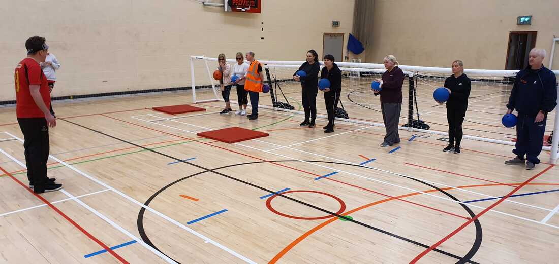 Picture shows a group blind and partially sighted people being taught GoalBall at one of our multi sport sessionns